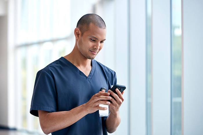 nurse looking at information on cell