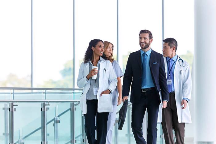 Custom-Photo Group-walking-in-hospital-hallway