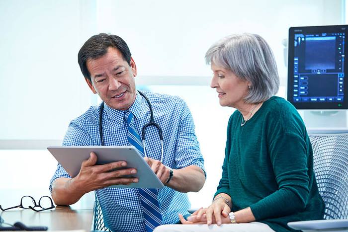 doctor and patient reading tablet