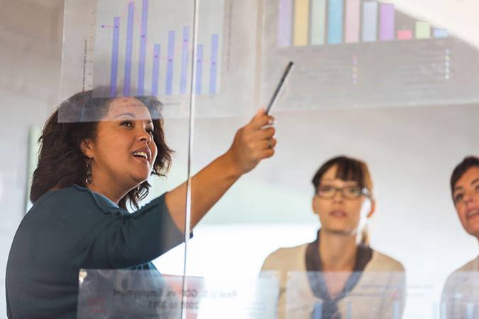 woman presenting bar graph