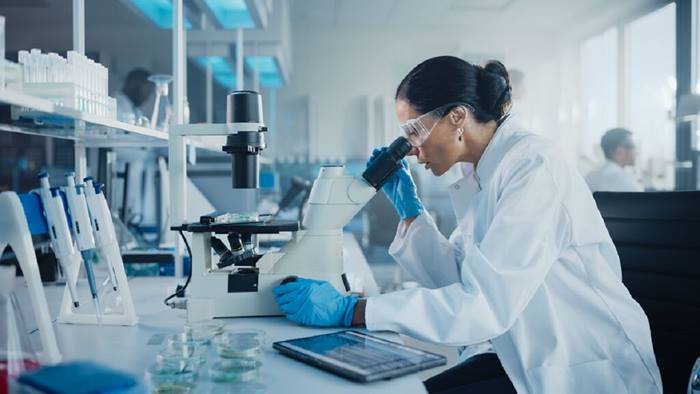 Scientist looking under microscope