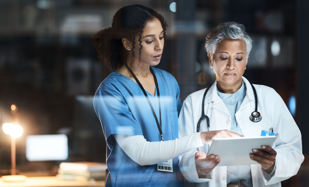 Doctor and nurse with digital tablet talking