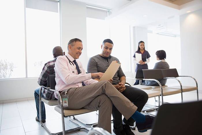 Doctor discussing medical record with patient