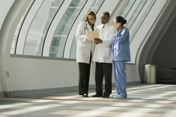 Doctors and nurse reviewing medical chart Edited