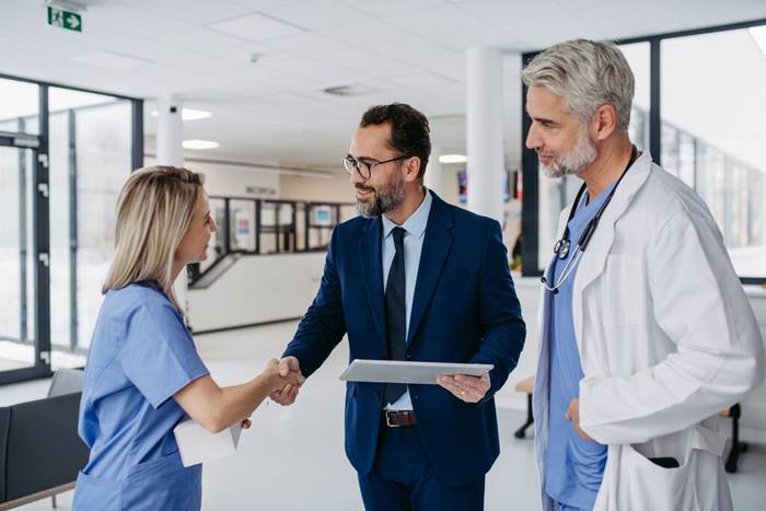 Pharmaceutical sales representative talking with doctors