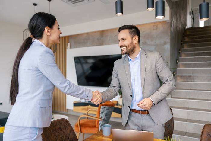 Two successful business people shaking hands at office